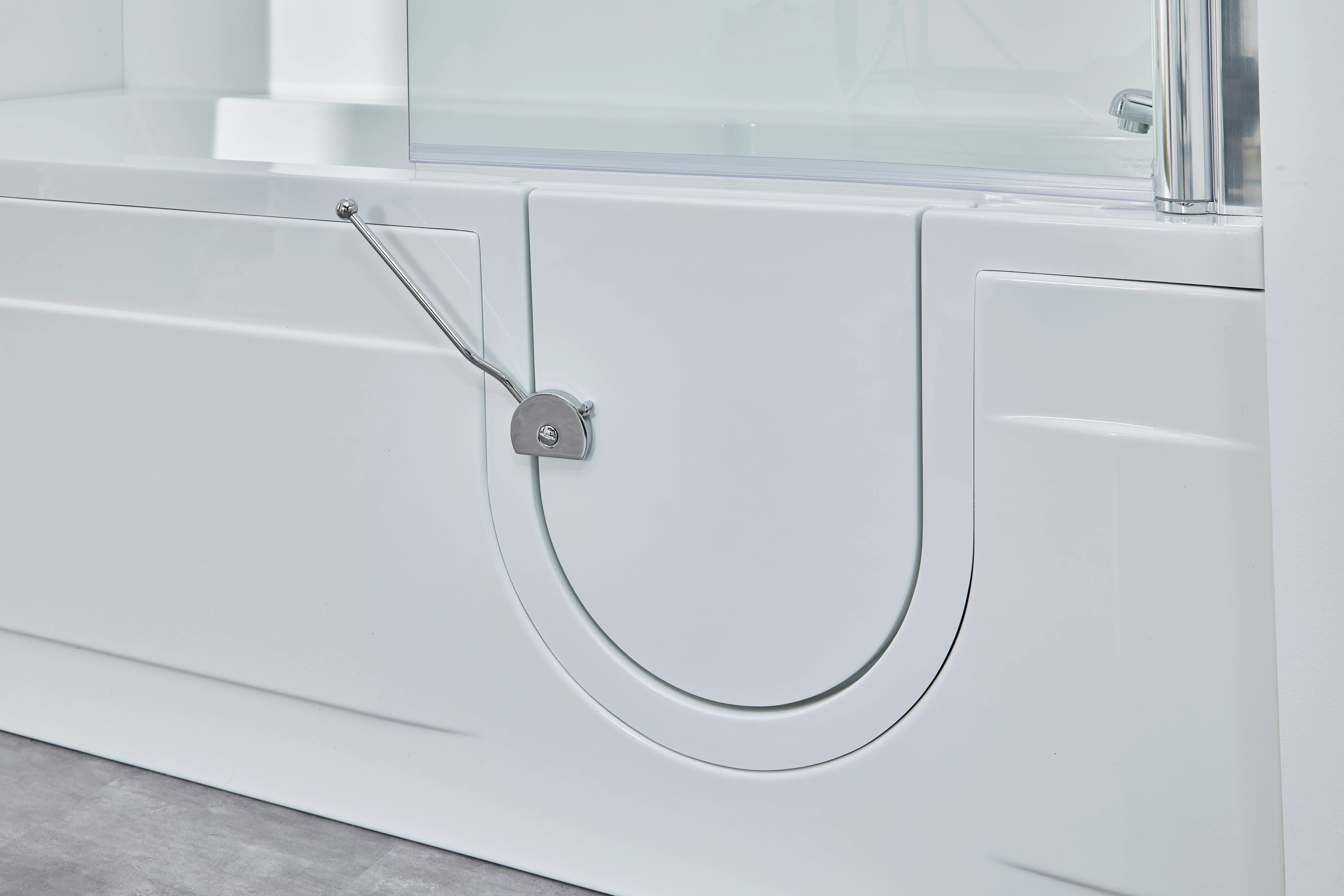 a close up of a white bath tub with a glass door