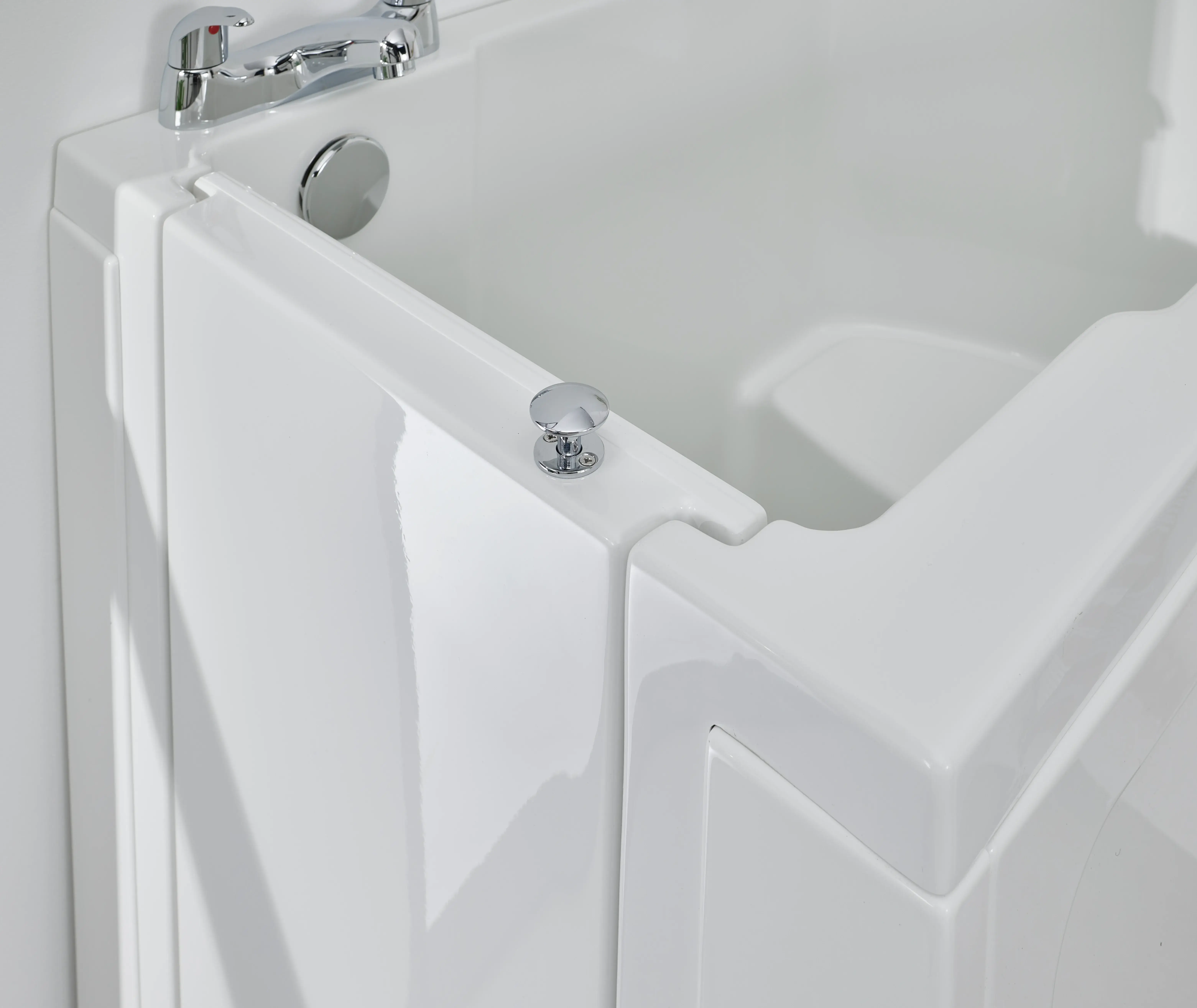 A white bath tub with a shower head and arm spout.
