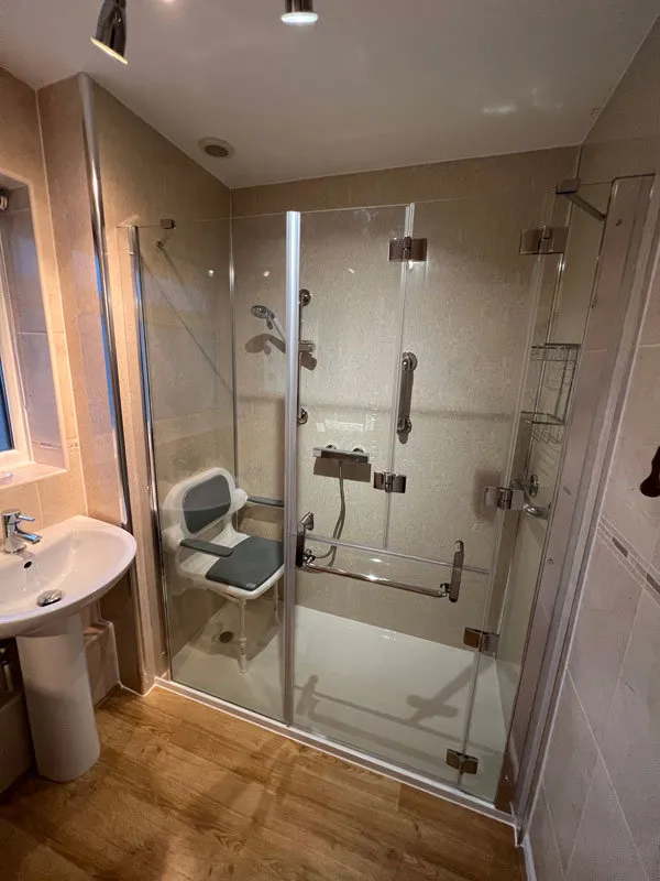 a bathroom with a shower, sink and toilet